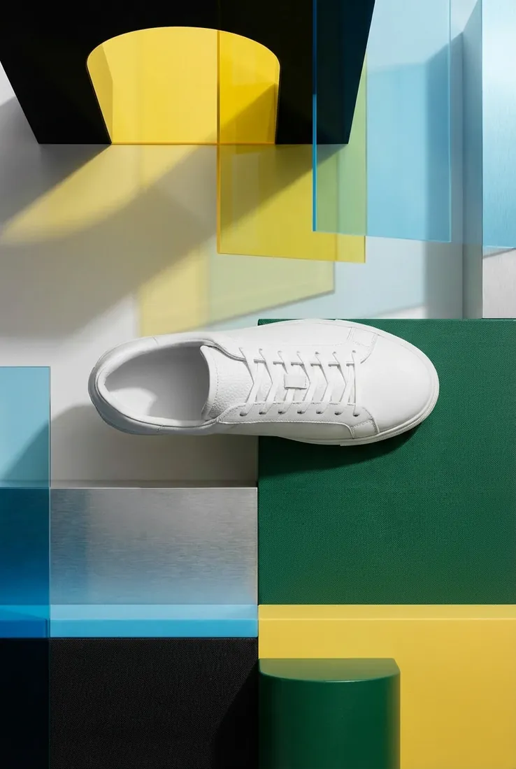 White sneaker, top-down view, on a studio set